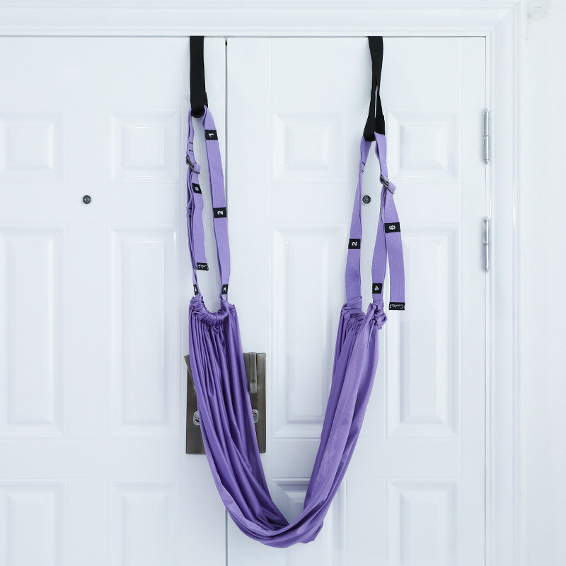 Yoga stretch strap hanging from a door