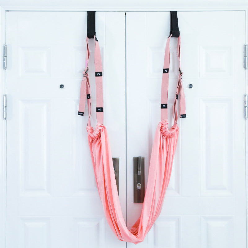 Yoga stretch strap hanging from a door